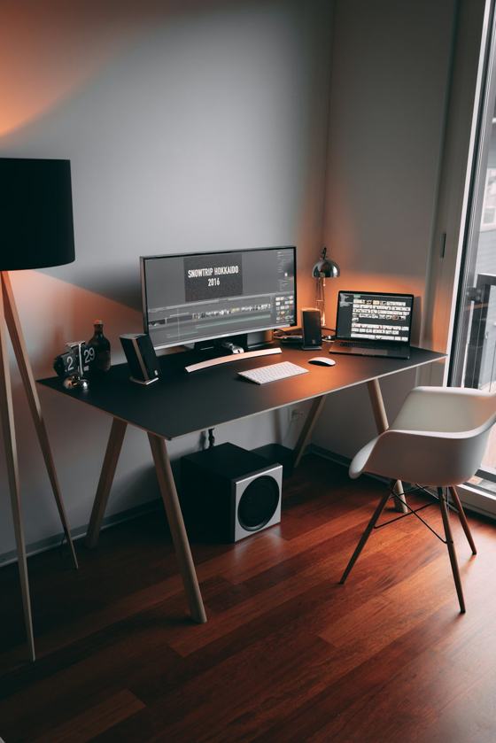 Black flat screen computer monitor on black wooden table