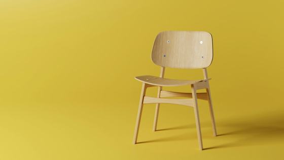 A wooden chair on a yellow background