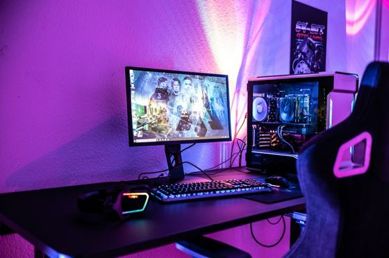 A desk with a computer and a gaming chair