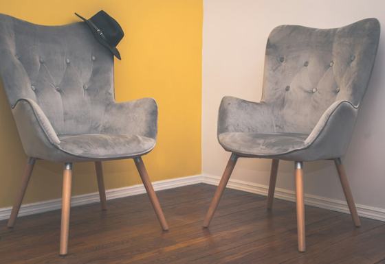 Gray padded chair on brown wooden floor