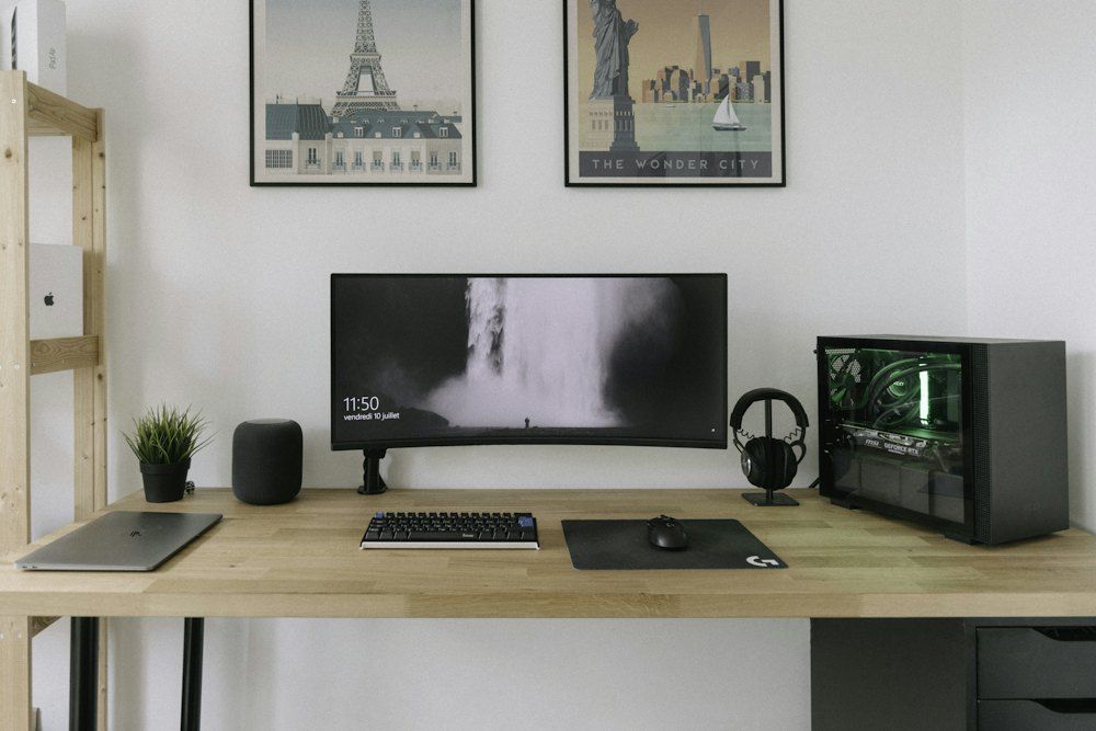 Black flat screen computer monitor on brown wooden desk