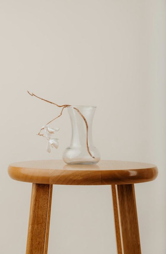 Clear glass vase on brown wooden table