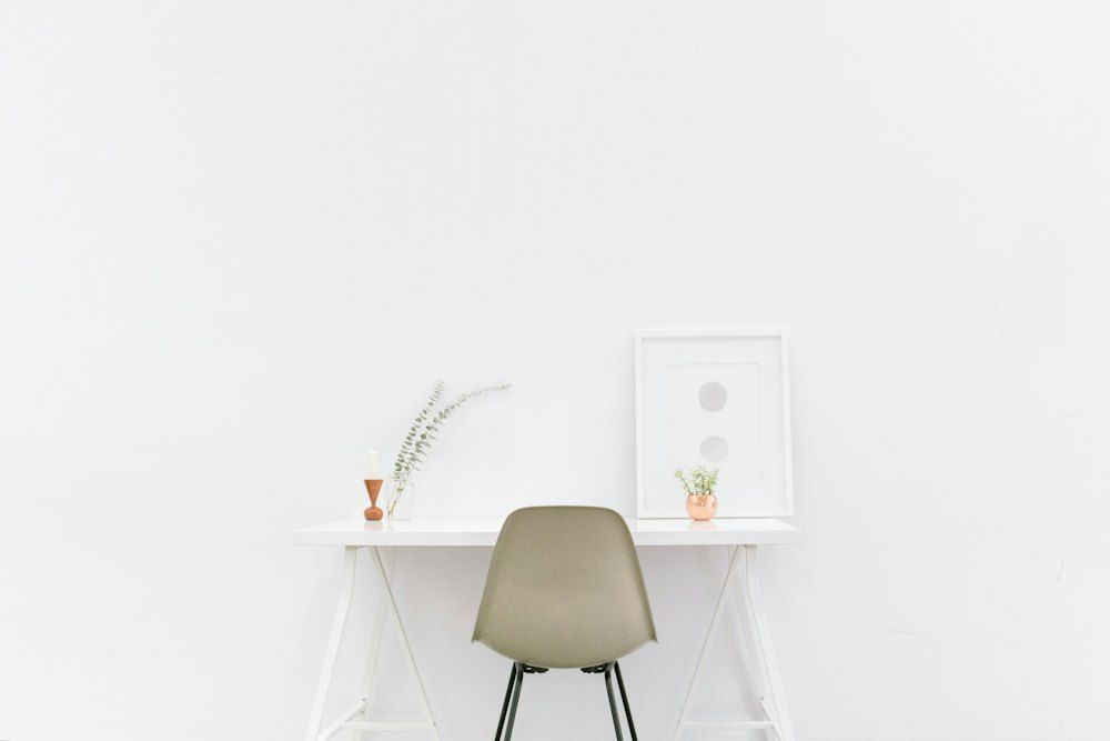 White wooden table near brown chair