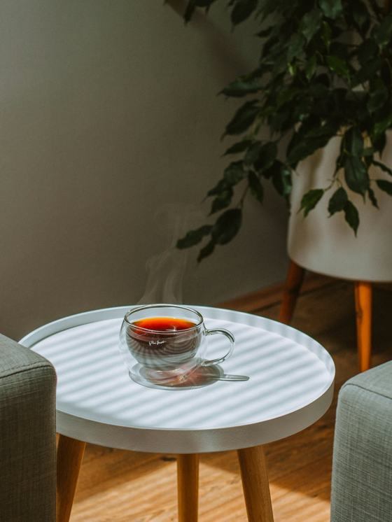 Clear glass teacup on white round table