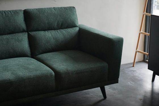 Gray cushion armchair beside white wall