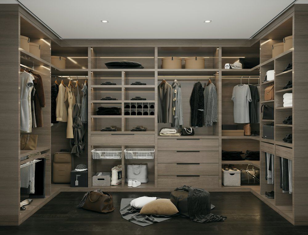 A walk in closet filled with lots of clothes