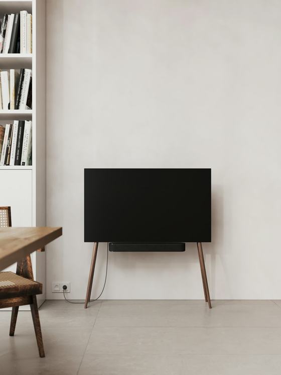 A black television sitting on top of a wooden stand