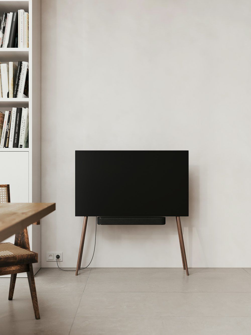 A black television sitting on top of a wooden stand