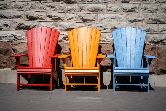 Red and blue wooden armchairs