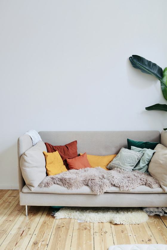Orange throw pillows on white couch