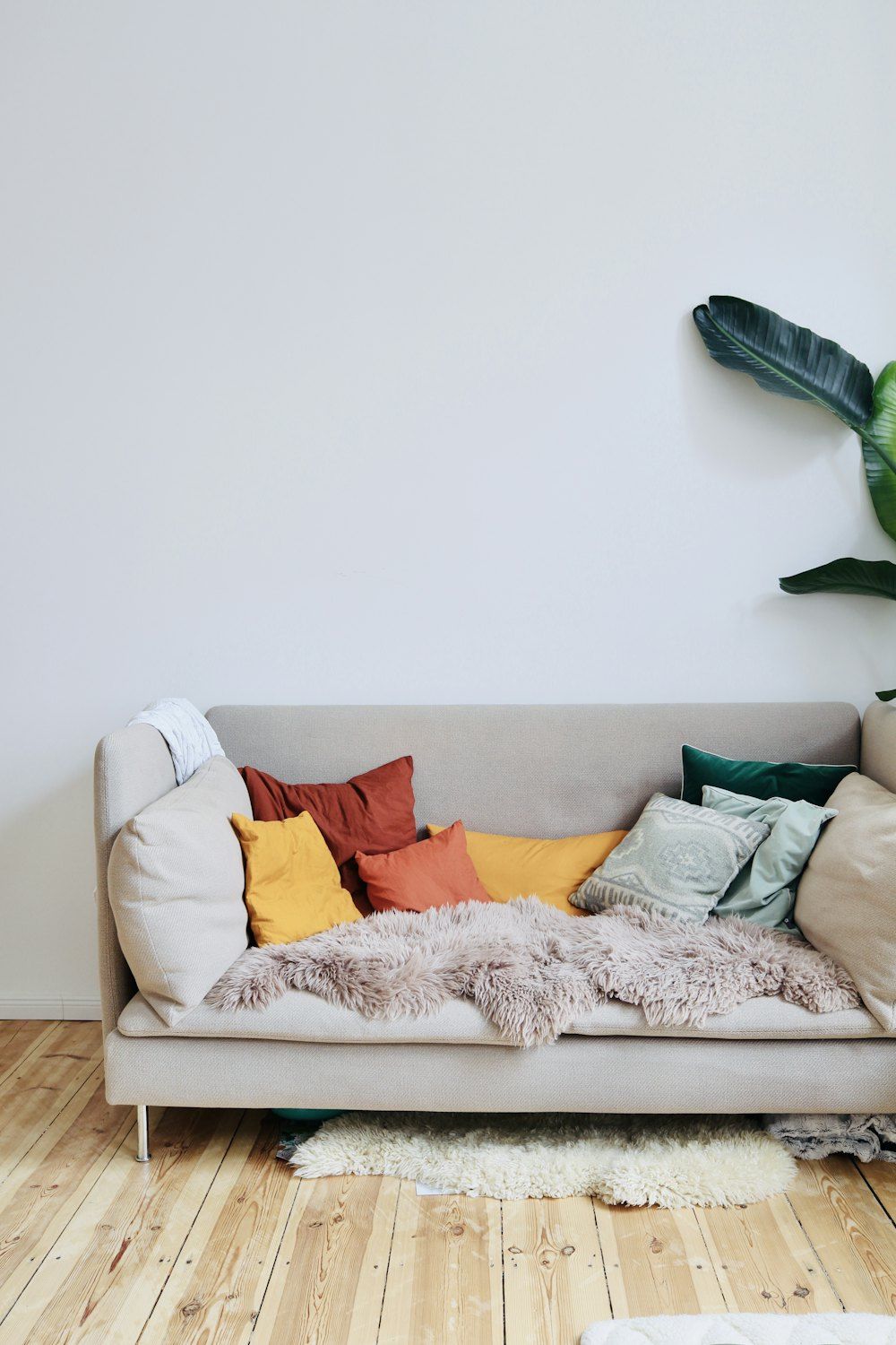 Orange throw pillows on white couch