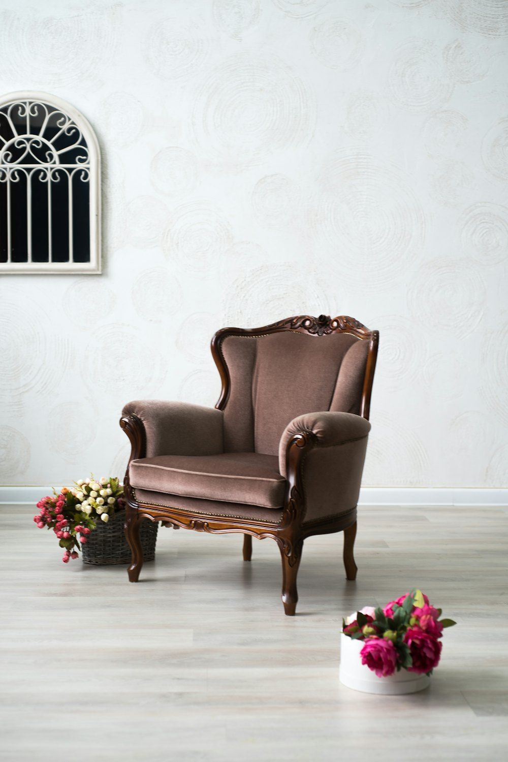 Brown leather armchair beside pink roses