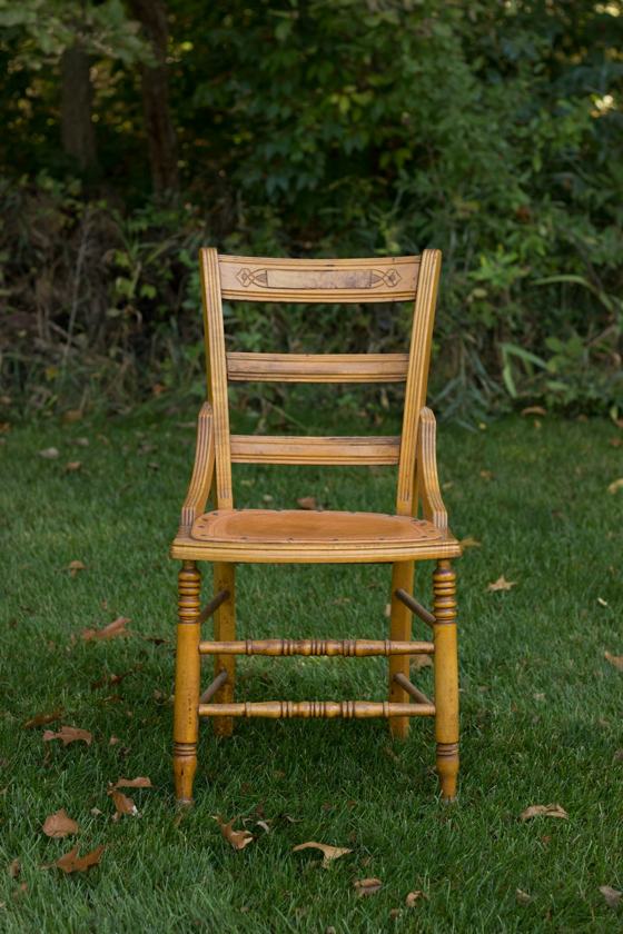 Brown wooden chair on grass covered plain