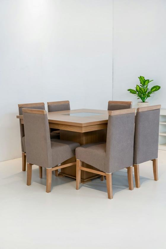 Dining table with six upholstered chairs in a bright room