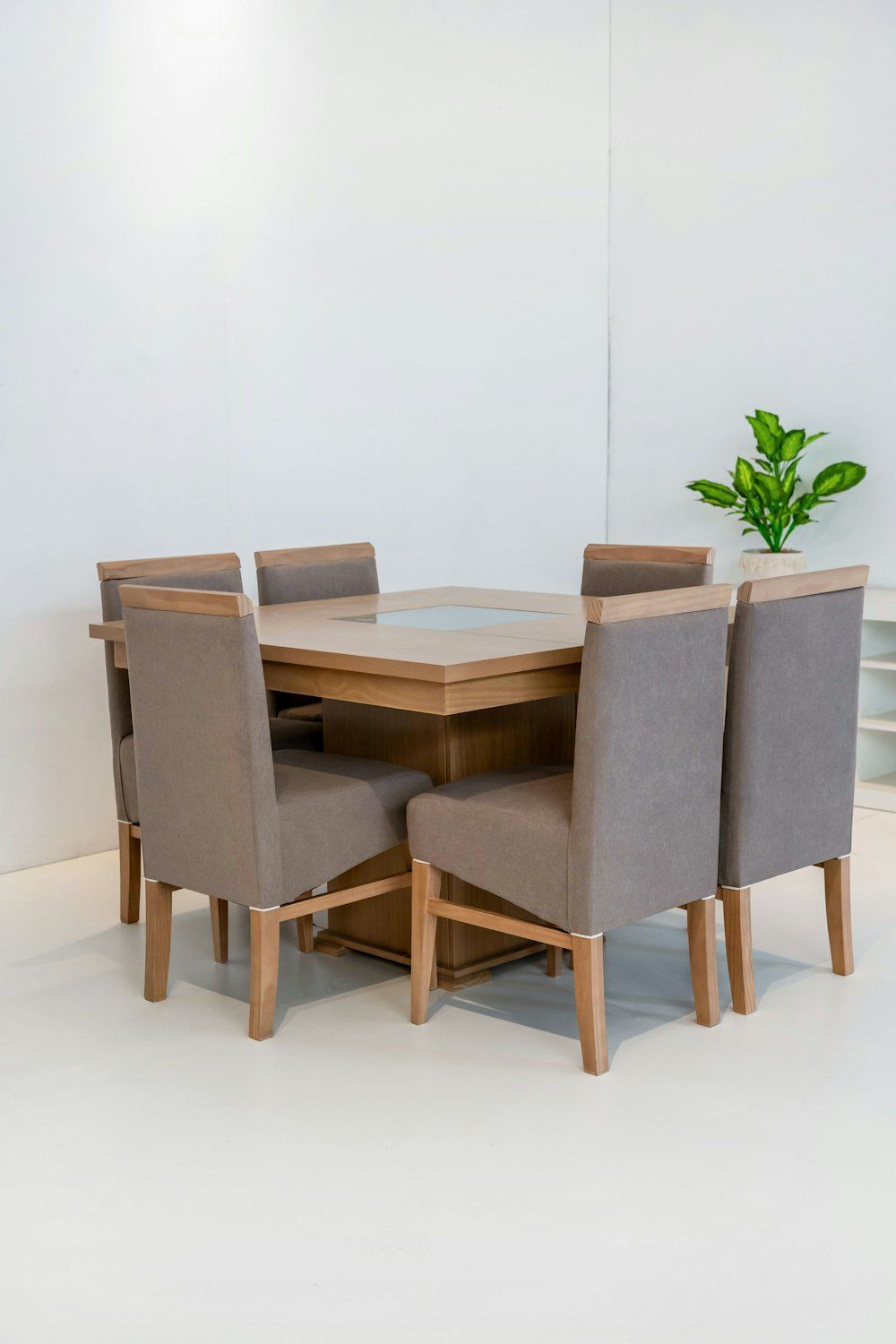 Dining table with six upholstered chairs in a bright room