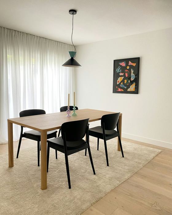 A dining room table with chairs