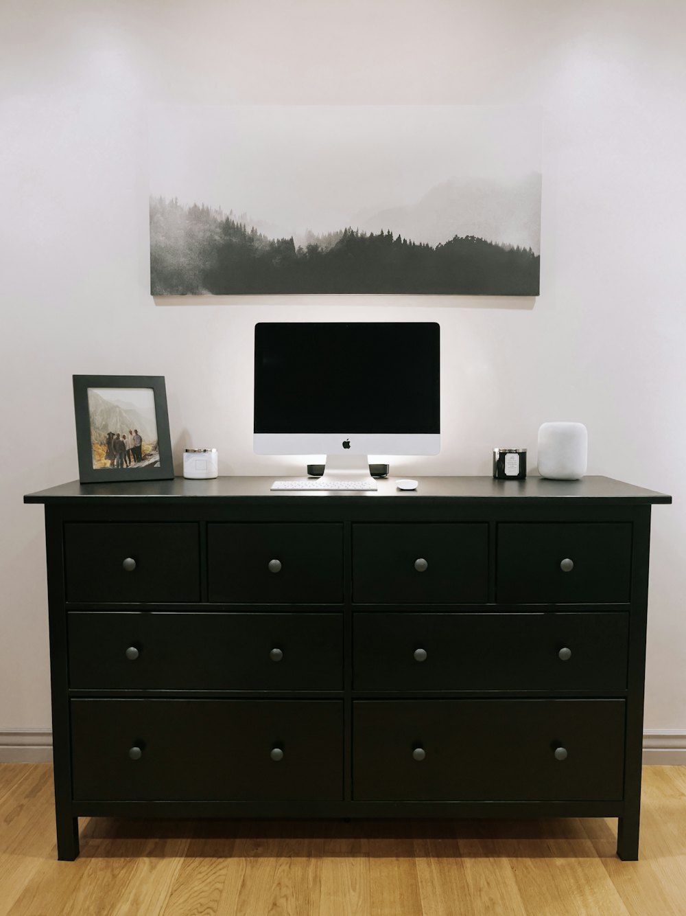 Black flat screen tv on white wooden drawer