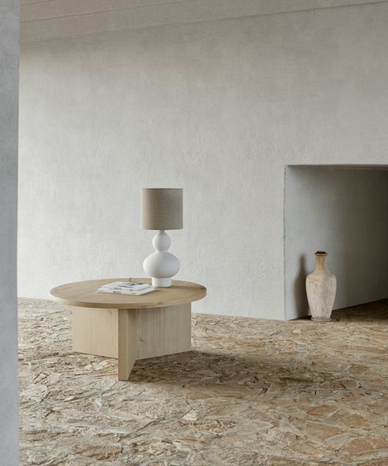 Brown wooden table with white ceramic vase on top