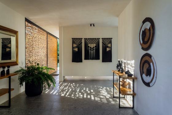 Modern hallway with decorative wall hangings and plants
