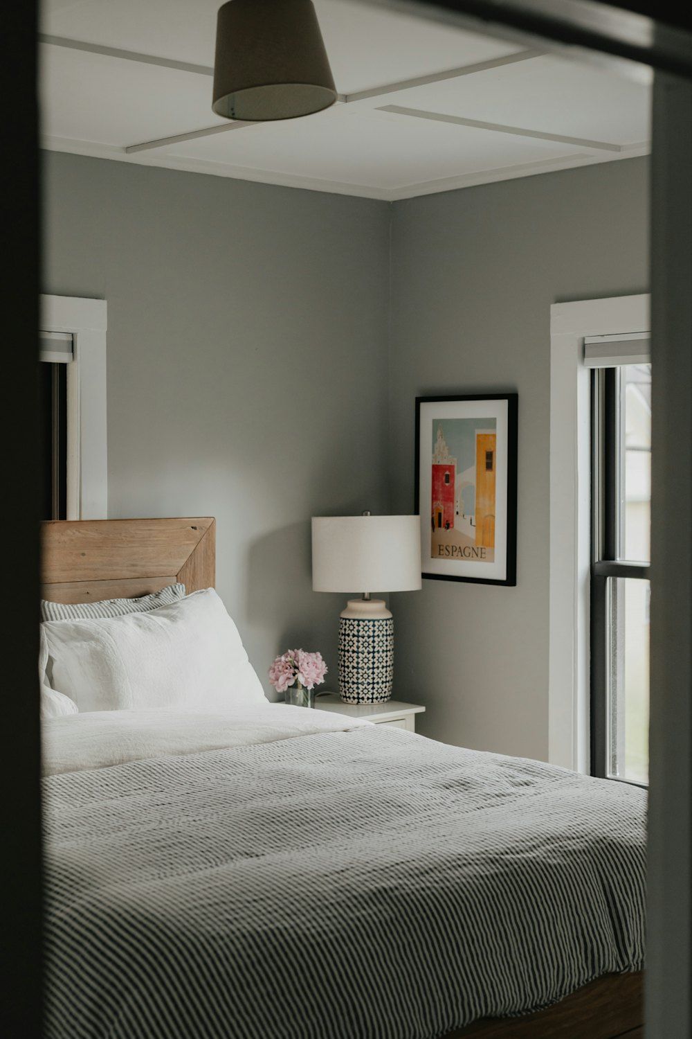 A bedroom with a bed and a lamp