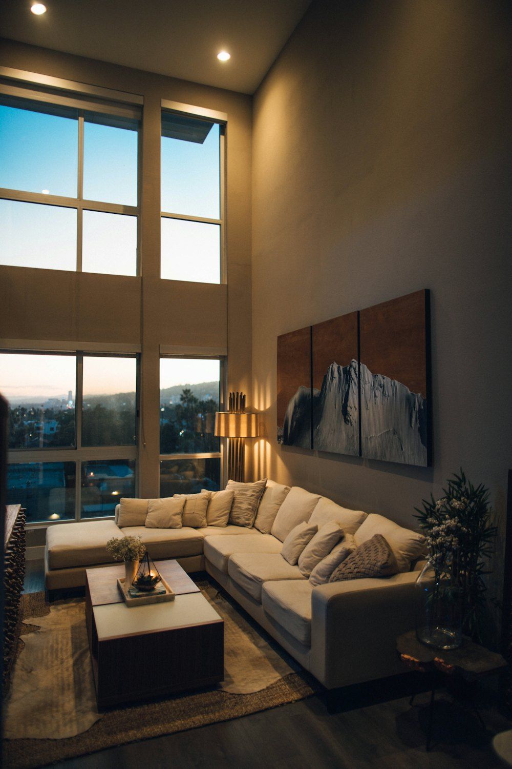 Gray padded chaise couch beside window