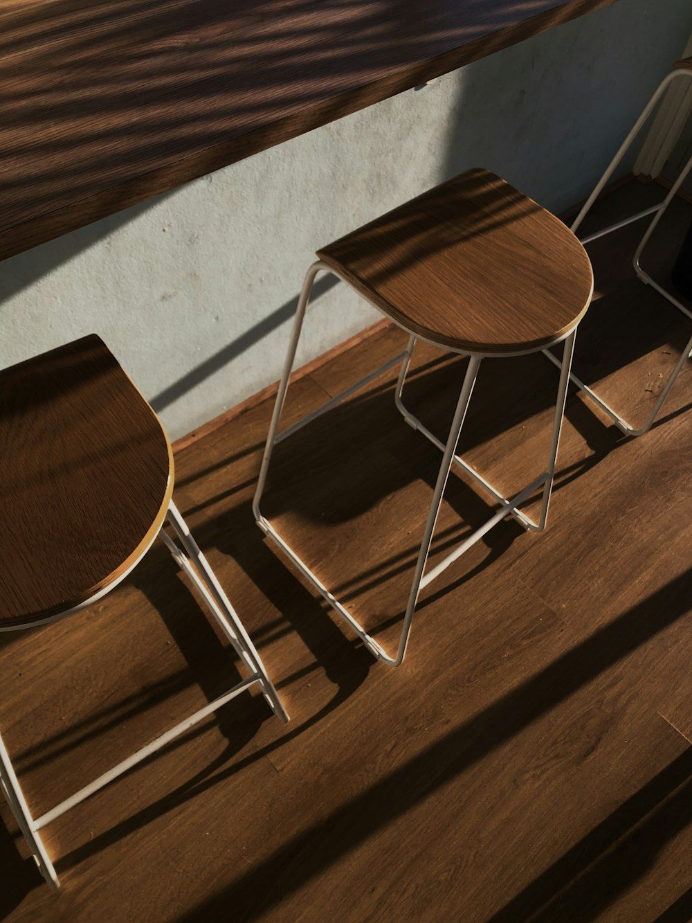 Brown wooden chair beside white wall