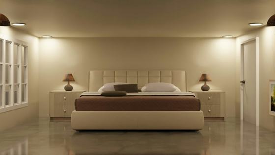 A bedroom with a large bed and two lamps
