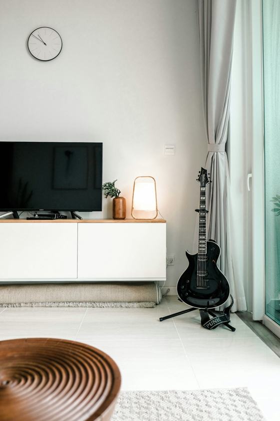 Black flat screen tv on white wooden tv rack