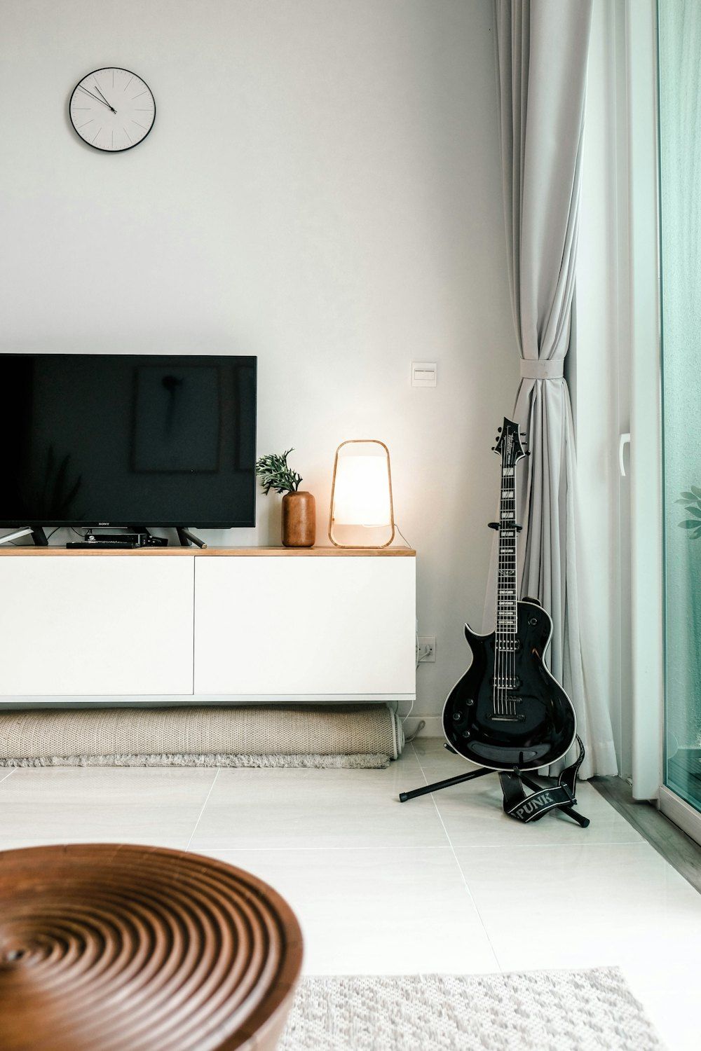 Black flat screen tv on white wooden tv rack