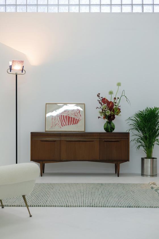 A living room with white walls and a white rug