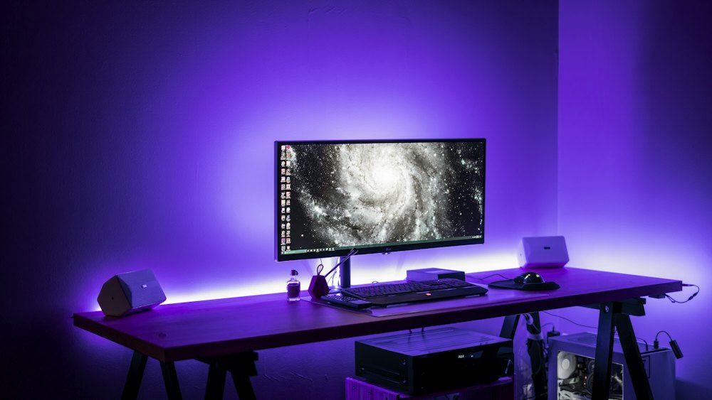 Flat screen computer monitor on brown computer desk