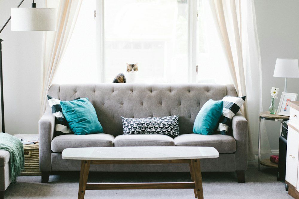 Brown and white wooden table beside sofa chair
