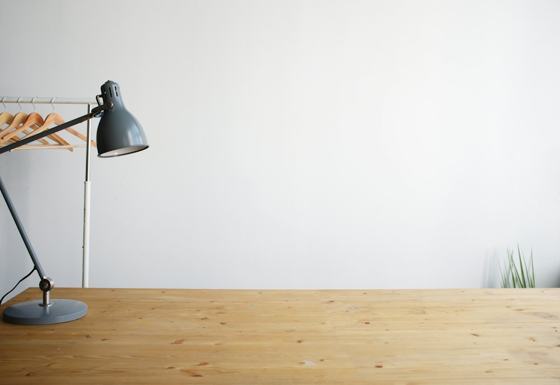 Gray balanced-arm lamp on brown wooden table