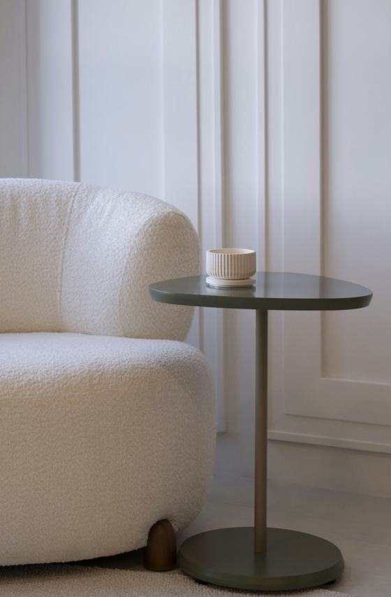 A cozy armchair next to a small side table
