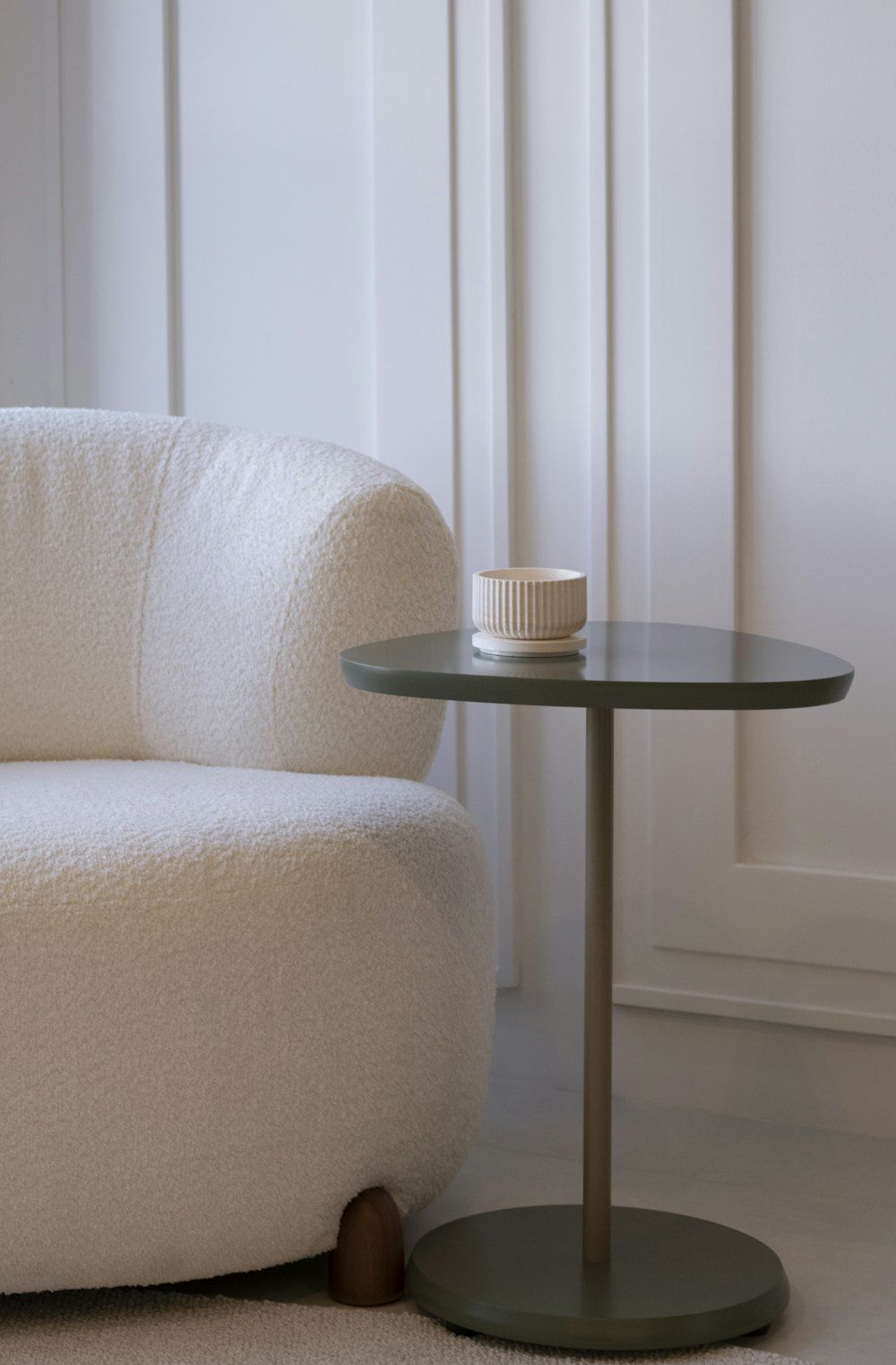 A cozy armchair next to a small side table