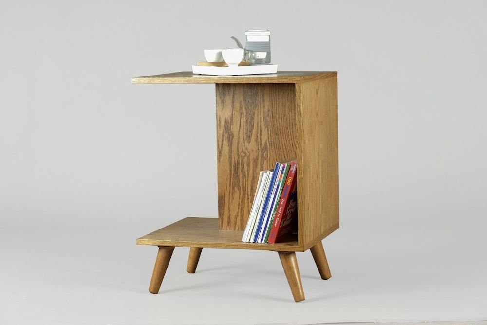 Brown wooden table with books and mugs