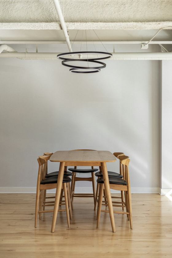 Brown wooden 5-piece dining set inside white building
