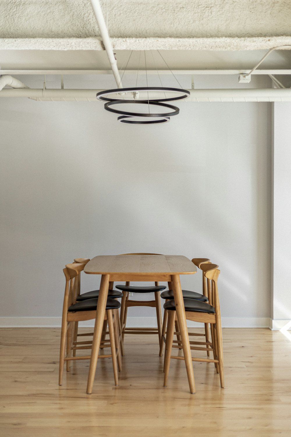 Brown wooden 5-piece dining set inside white building