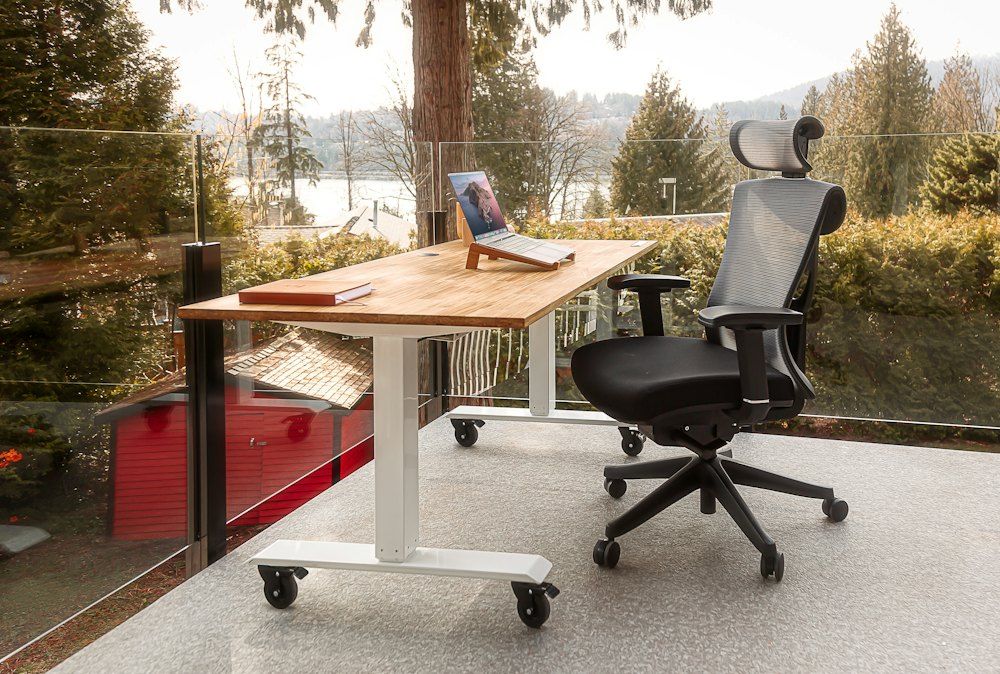 A desk with a laptop on top of it