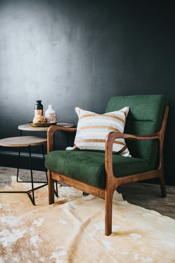White throw pillow on green sofa chair