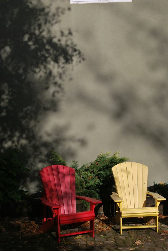A couple of red and yellow chairs sitting next to each other