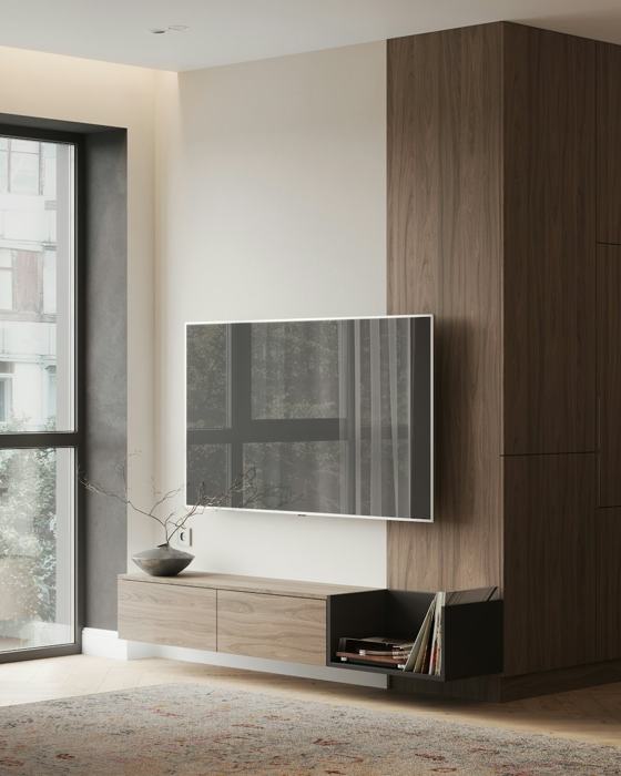 A living room with a large television on a wall